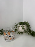 Brown faces and flowers whiskey glass