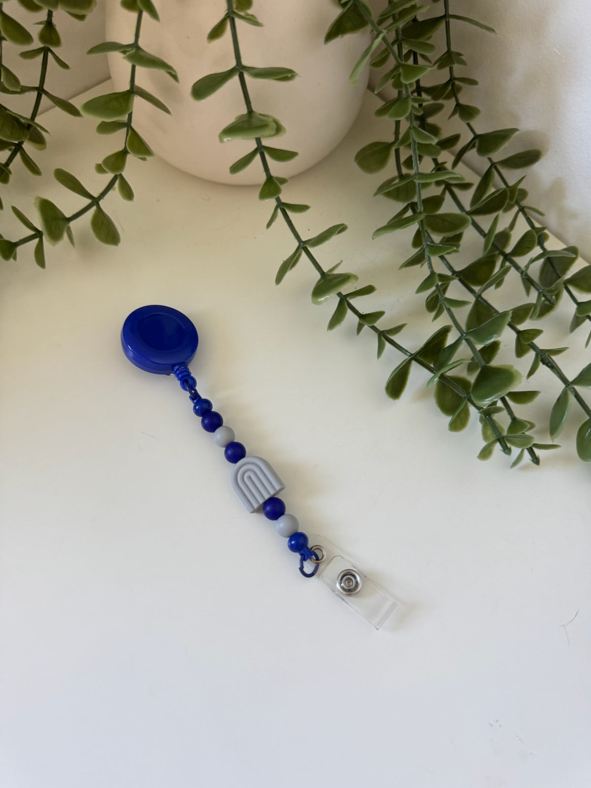 Grey and blue arch badge reel