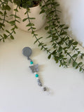 Grey butterfly badge reel