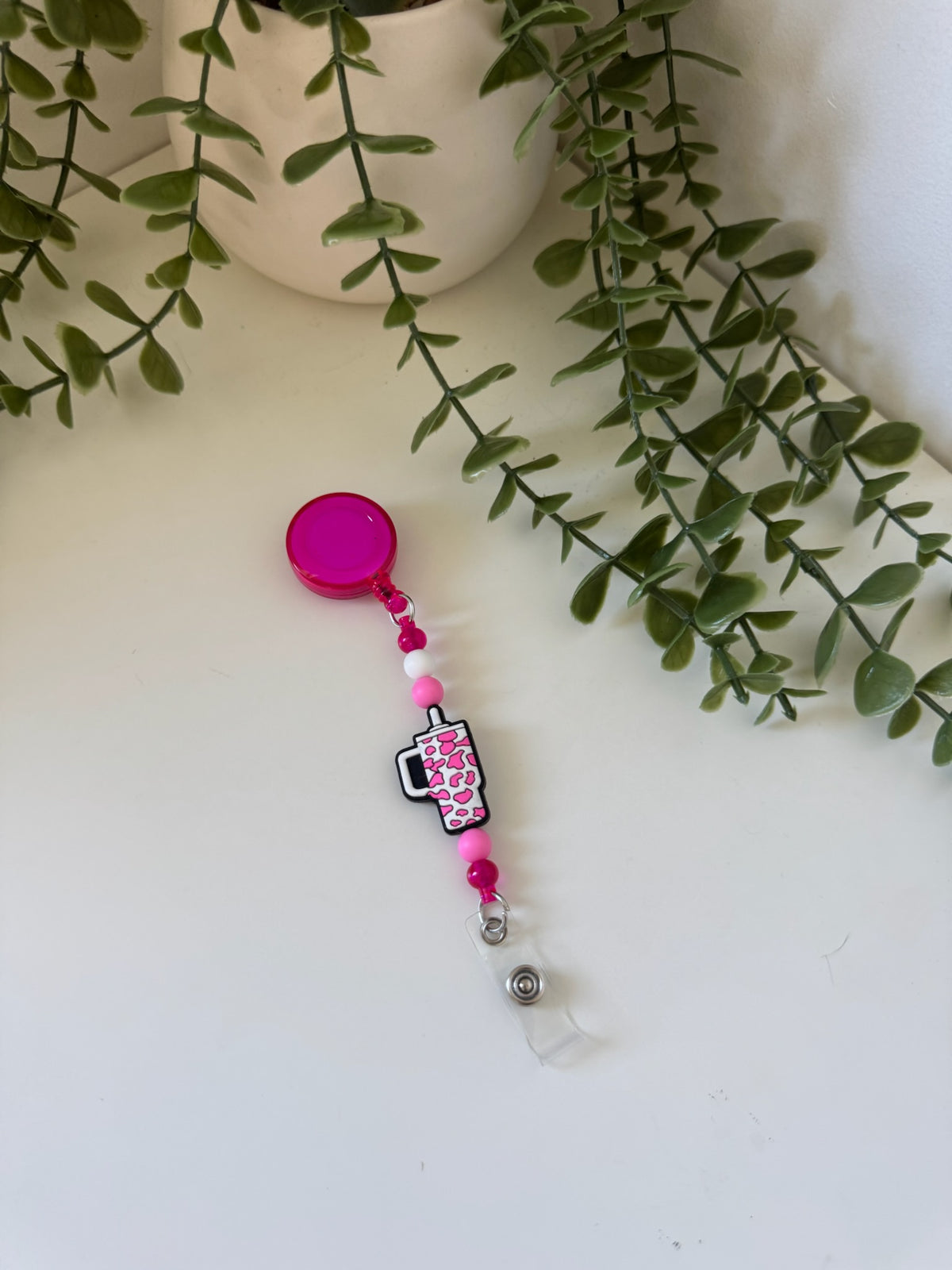 Pink cup badge reel