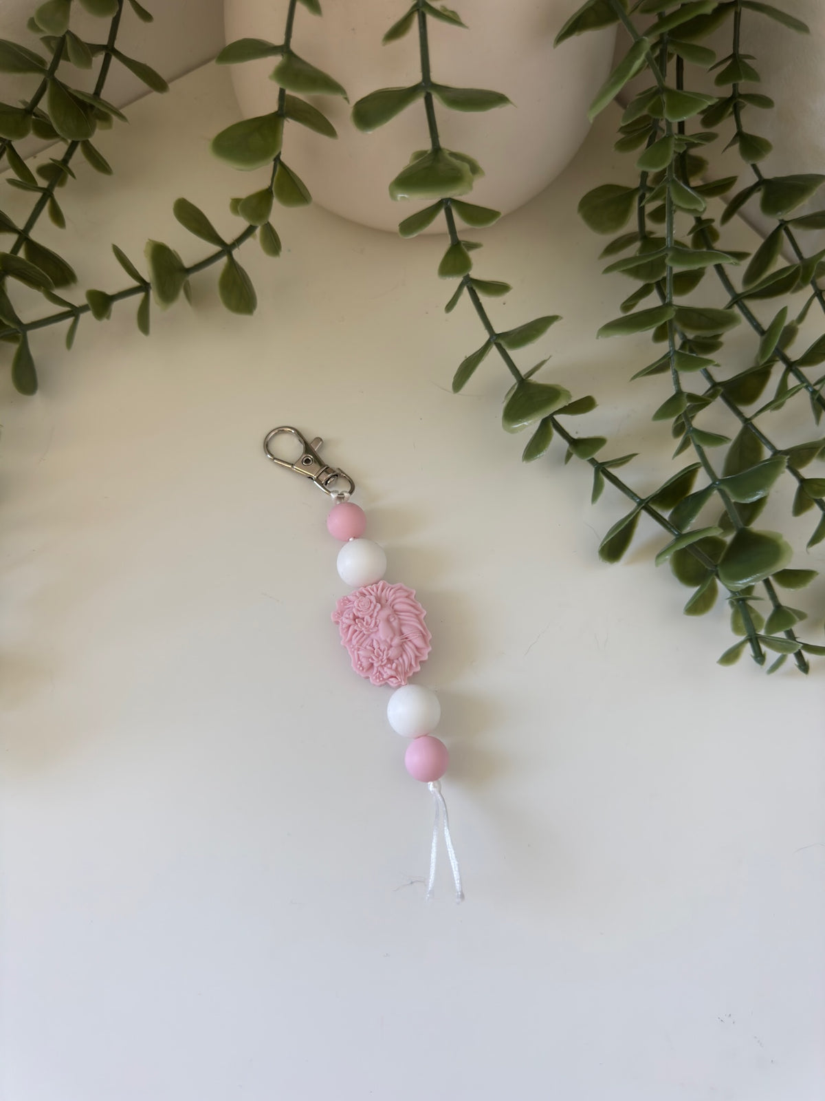 Pink lion head string key chain