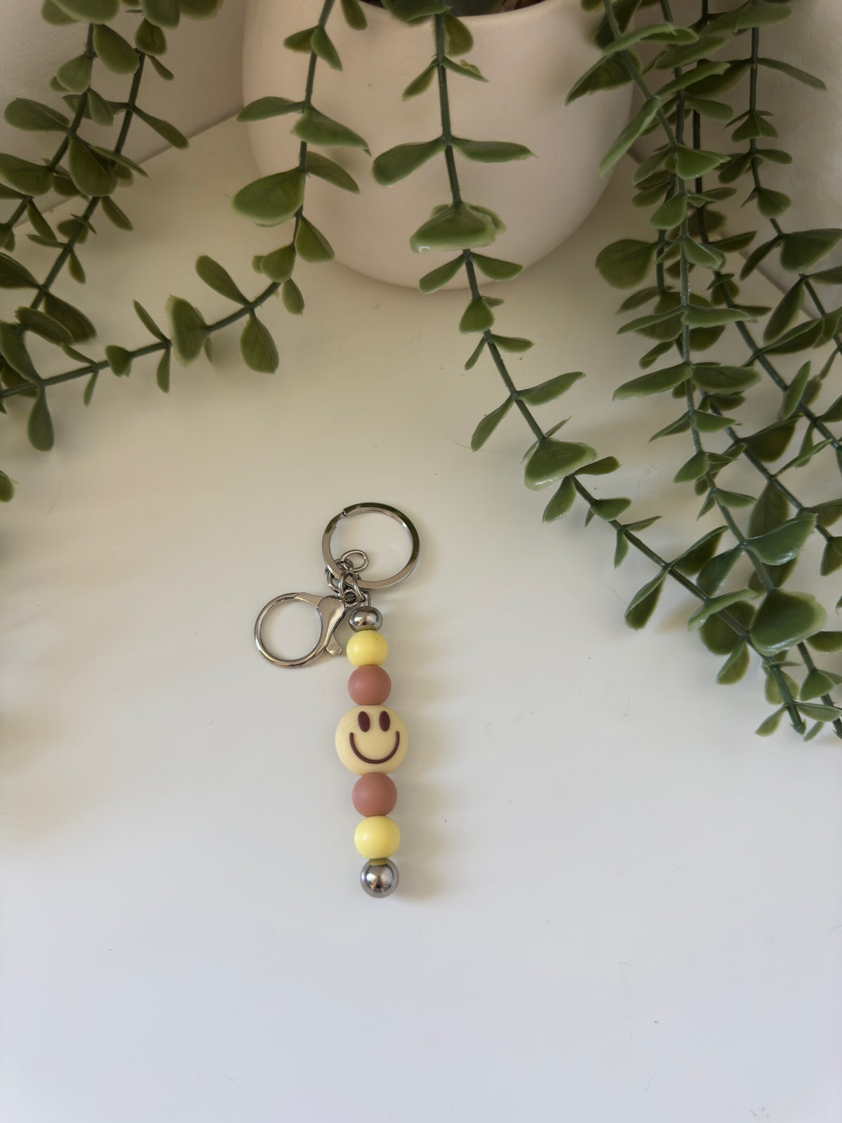 Yellow smiley metal keychain